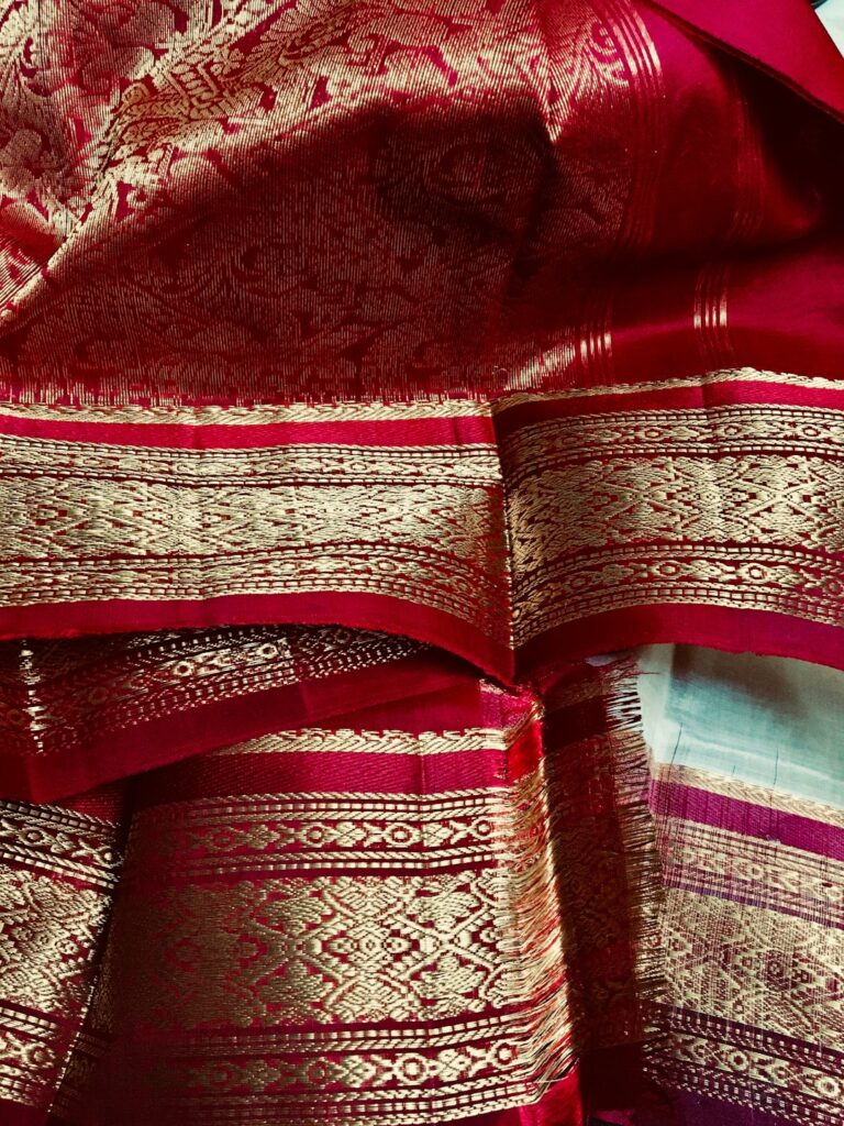 Close-up of a silk saree with a gold zari border