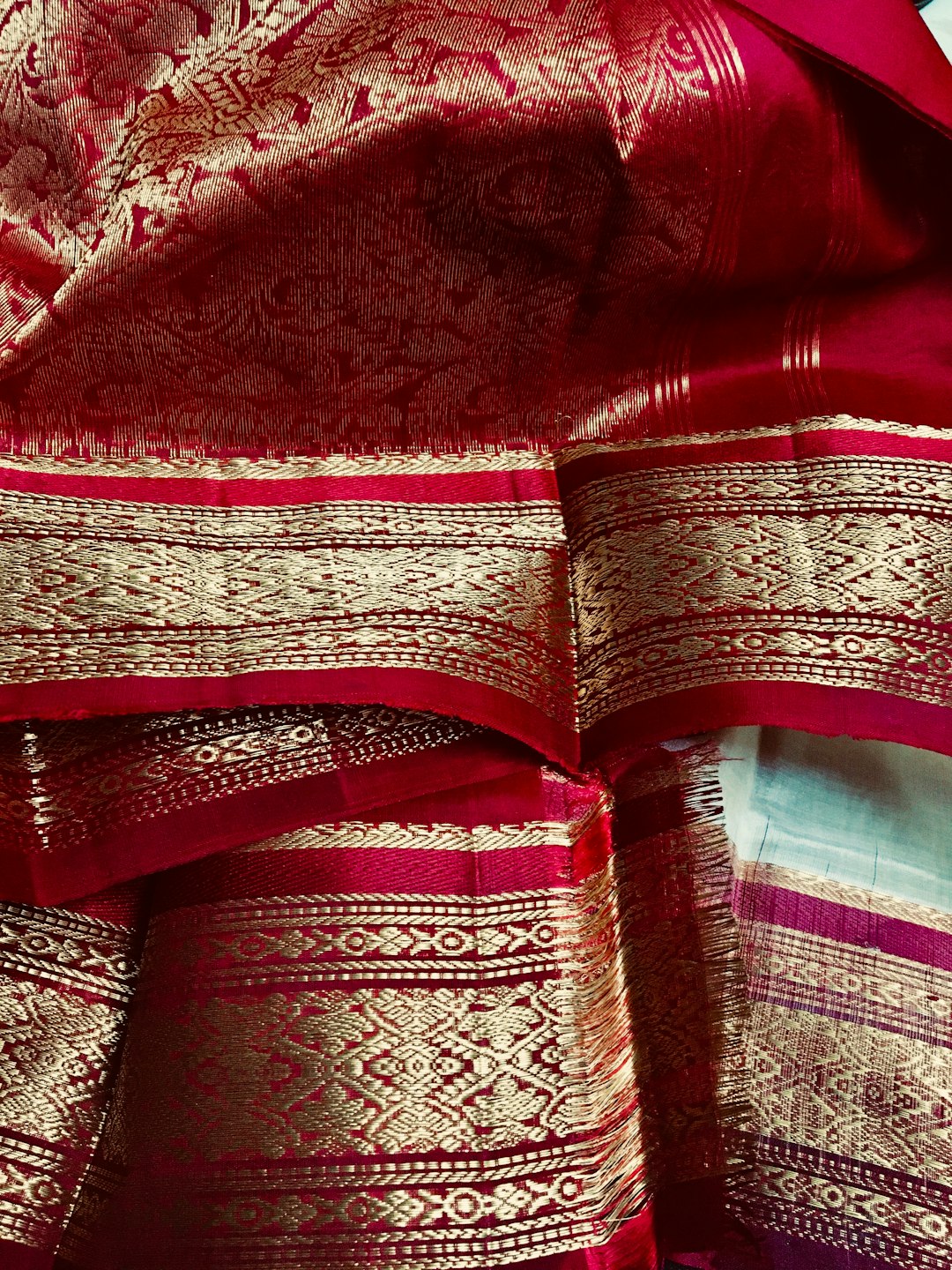 Close-up of a silk saree with a gold zari border