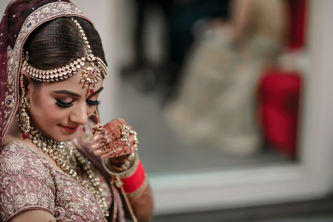 Bride in a red and gold saree for wedding season
