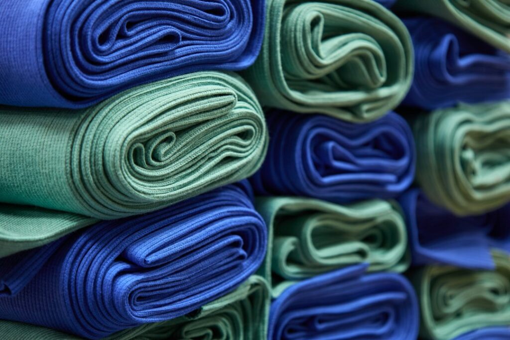 Stack of folded fabrics representing India's textile exports